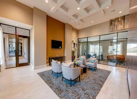 a living room with couches and chairs and a television