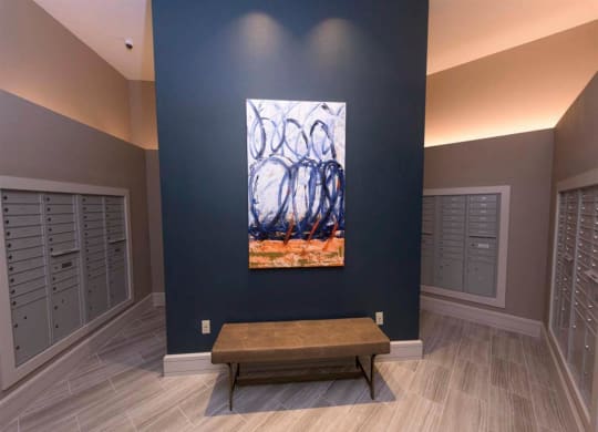 a painting on a wall in a room with a bench