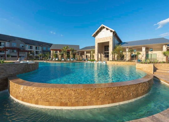 a large pool with a house in the background