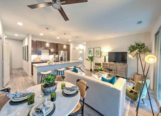 a kitchen and living room with a table and chairs