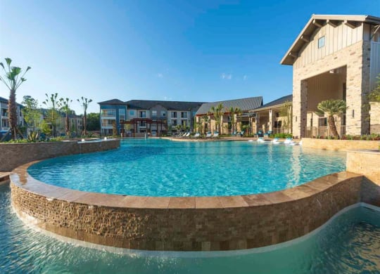 a large swimming pool with a building in the background