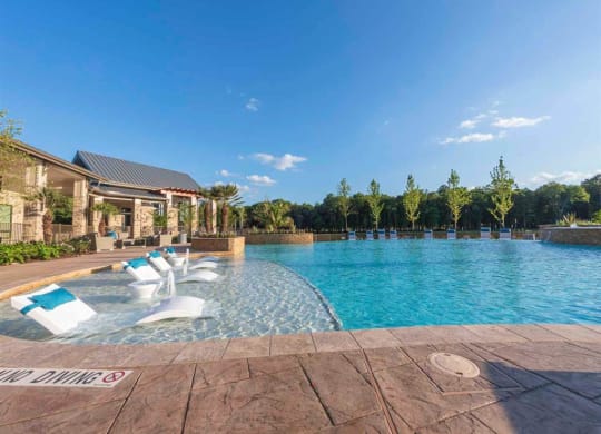 a swimming pool with chairs and a house in the background