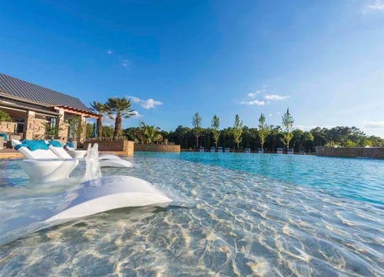 a large swimming pool with a pool house and water jets