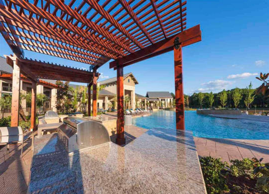 a pergola overlooking a swimming pool at a resort