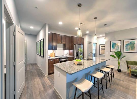 a kitchen with a long island with bar stools