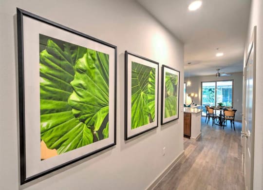 large pictures on the wall in the living room of a house