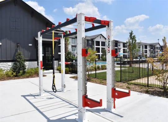 an outdoor swing set in front of a building