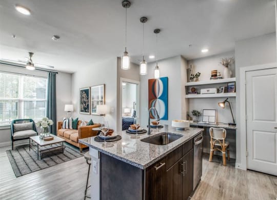a kitchen with an island and a living room