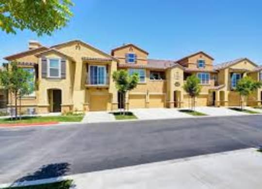 A row of houses with a driveway in front.