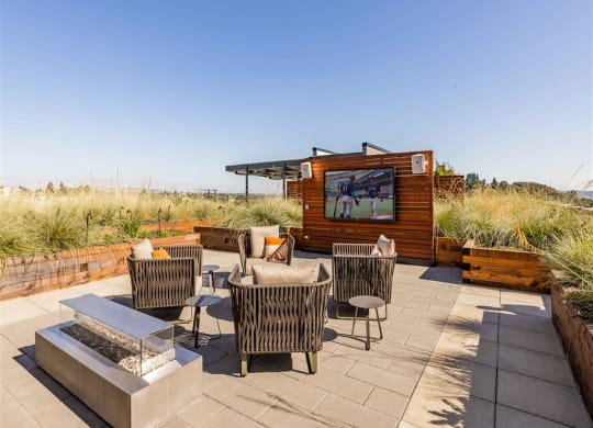 a patio with a tv and chairs
