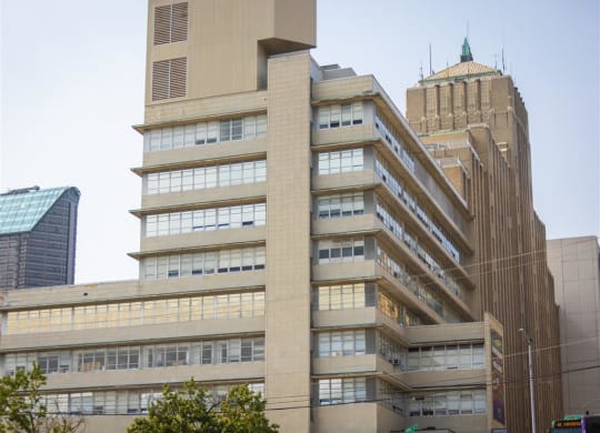 a large building with many windows and a tower in the background