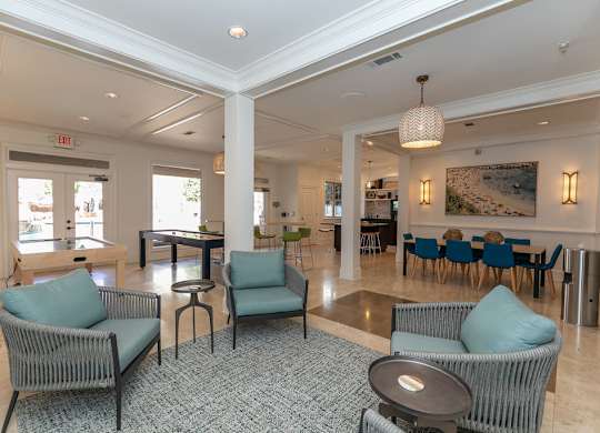 a resident clubhouse with couches tables and chairs and a pool table at Westmount at Ashwood, Atlanta, Georgia