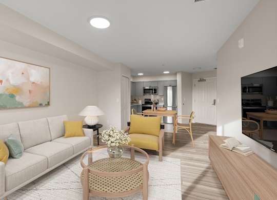 A living room with a white couch and yellow pillows.