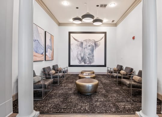 a lobby with couches and chairs and a picture of a bull at Mission Gate, Texas