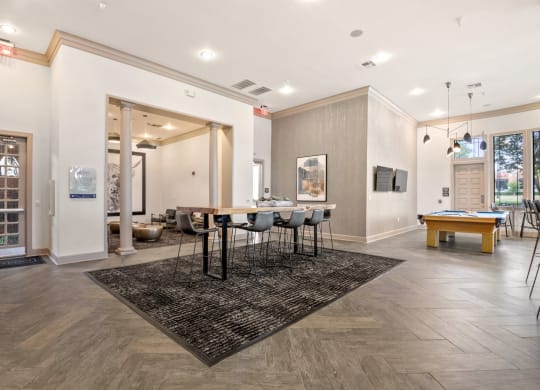 Welcoming space in the resident clubhouse with dining room table and pool table at Mission Gate, Plano, 75024