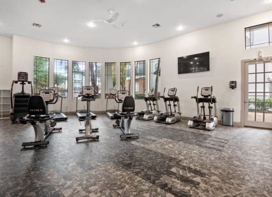 the gym with treadmills and cardio equipment at the preserve at great neck apartments at Mission Gate, Plano, TX