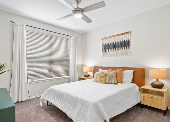 a bedroom with a bed and a ceiling fan at Mission Gate, Plano, 75024