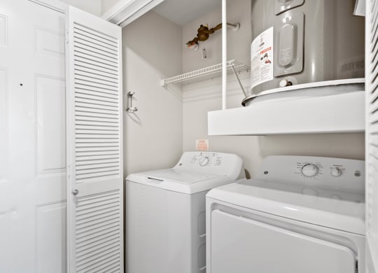 a laundry room with a washer and dryer and a closet at Mission Gate, Texas, 75024