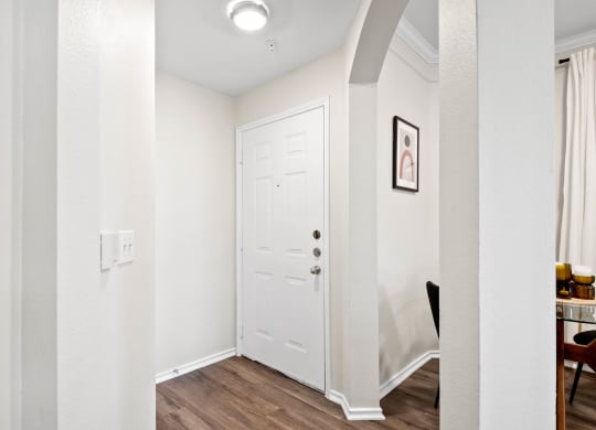 a hallway with a white door and white walls and a door to a closet at Mission Gate, Plano, TX, 75024