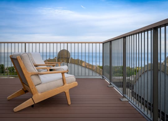a lounge chair on a balcony overlooking the ocean at the Belden Stratford in Chicago, IL 60614