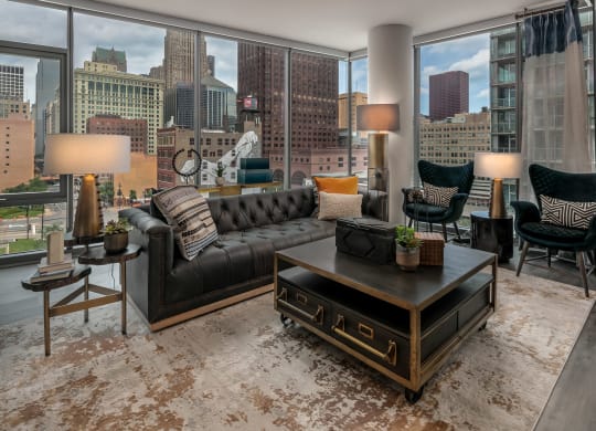 a living room with a city view and a couch and a table at The Grand Central, Chicago Illinois