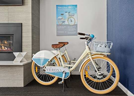 a bike parked next to a wall in a lobby  at Verona, Littleton, CO