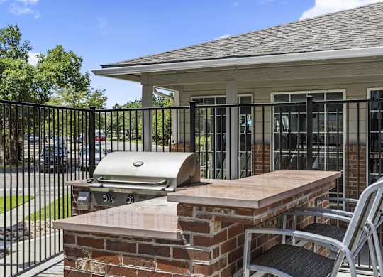 a patio with an outdoor grill and a table with chairs  at Verona, Littleton, CO, 80123