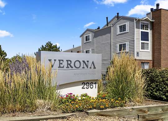 an apartment building with a sign in front of it  at Verona, Littleton, 80123