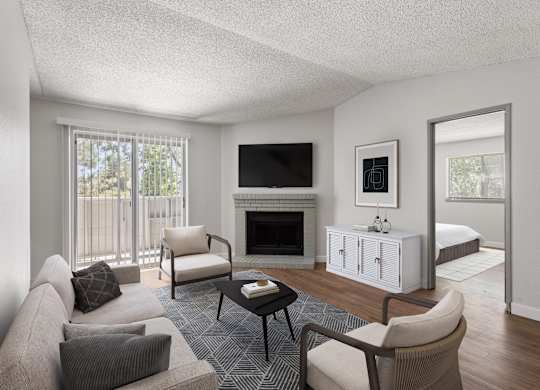 a living room with a couch and a chair and a fireplace  at Verona, Colorado, 80123