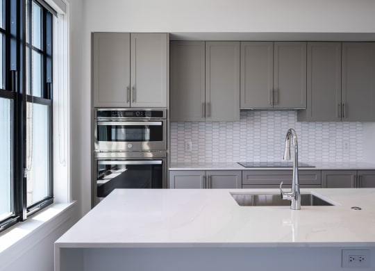 a kitchen with white counter tops and stainless steel appliances  at The Belden Stratford, Chicago, Illinois