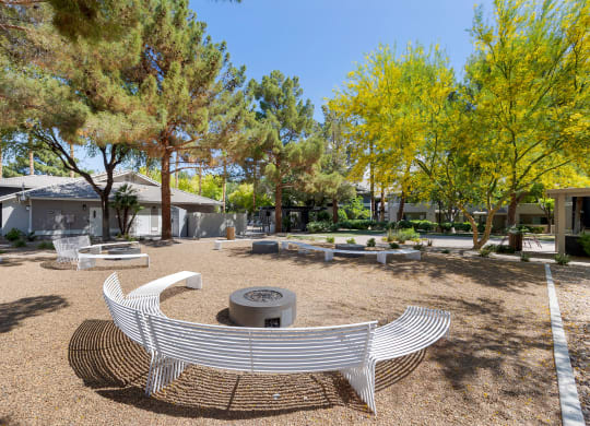 a fire pit and benches in a park with trees at Paisley and Pointe Apartments, Las Vegas, NV