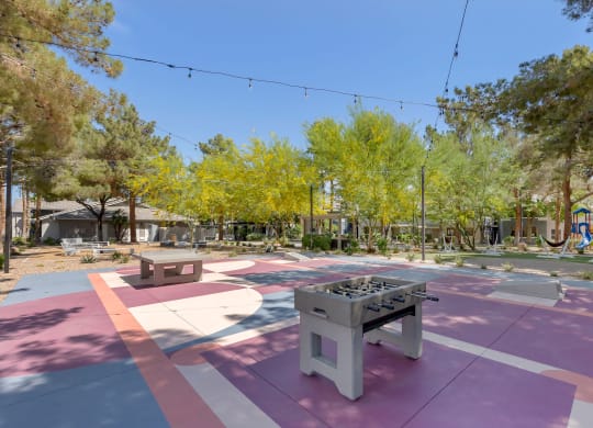 a park with a ping pong table and benches at Paisley and Pointe Apartments, Nevada, 89130