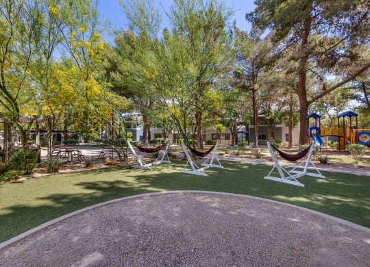 a group of hammocks in a park with a playground at Paisley and Pointe Apartments, Las Vegas, 89130