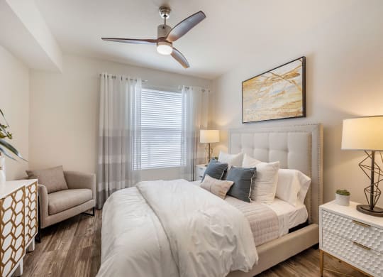 a bedroom with a large bed and a ceiling fan at Paisley and Pointe Apartments, Las Vegas, NV 89130