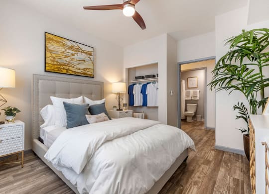 a bedroom with a white bed and a ceiling fan at Paisley and Pointe Apartments, Nevada, 89130