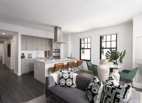 the living room and kitchen of an apartment with a couch and a table  at The Belden Stratford, Chicago, 60614