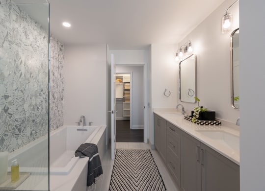 a bathroom with a tub and sink and a shower  at The Belden Stratford, Chicago, IL