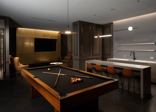 a dark room with a pool table and a bar  at The Belden Stratford, Illinois, 60614