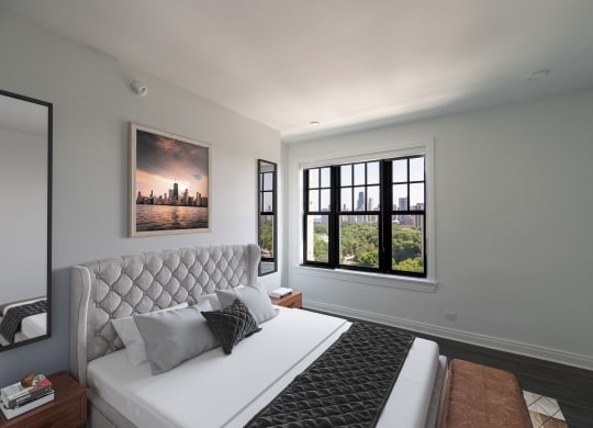 a bedroom with a white bed and a large window  at The Belden Stratford, Chicago, IL
