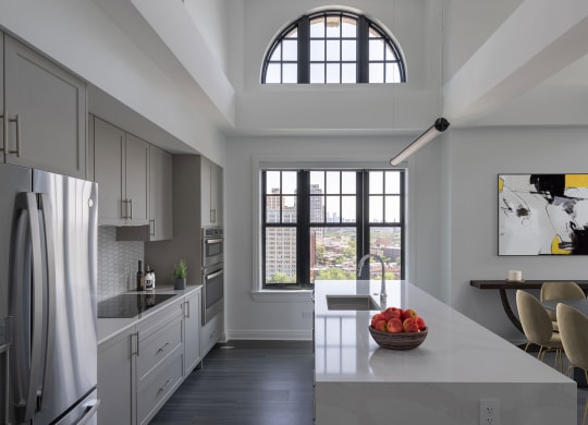 a kitchen with a large window and a table with chairs  at The Belden Stratford, Illinois, 60614