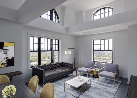 a living room with couches and a table  at The Belden Stratford, Chicago, IL