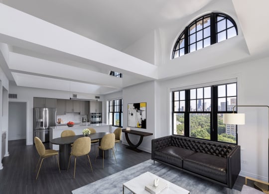 a living room with a couch and a table with chairs  at The Belden Stratford, Chicago, IL