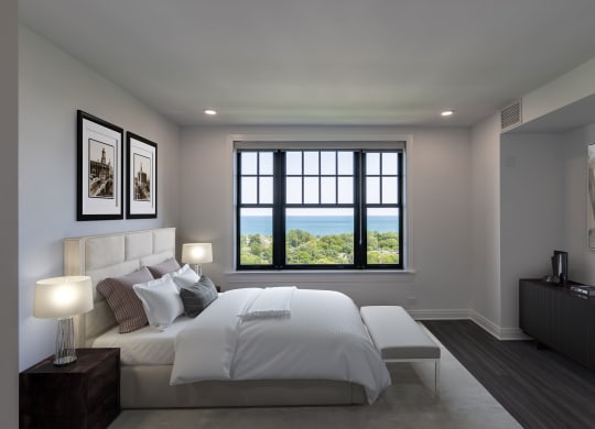 a white bedroom with a large bed and a window  at The Belden Stratford, Chicago, IL