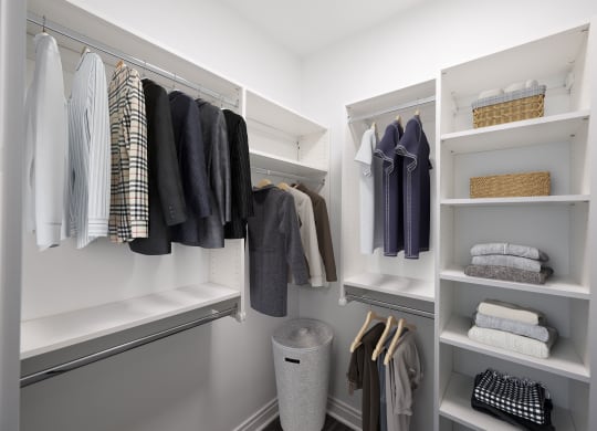 a walk in closet with white shelves and a closet organizer  at The Belden Stratford, Chicago, IL, 60614