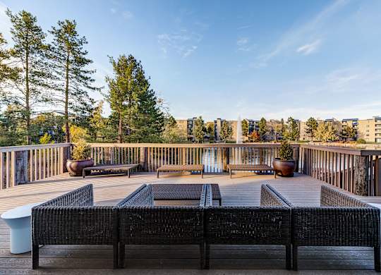 a deck with a fire pit and a view of the city at Ashford Belmar Apartments, Colorado