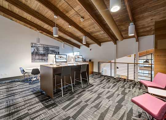 an office space with a desk and chairs and a bar with chairs at Ashford Belmar Apartments, Colorado, 80226