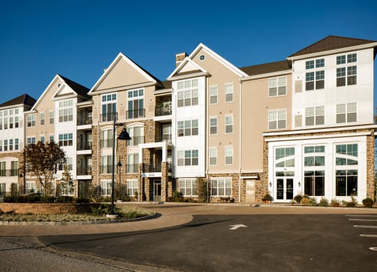 a large apartment building with a roundabout at Heights at Glen Mills, Glen Mills, 19342