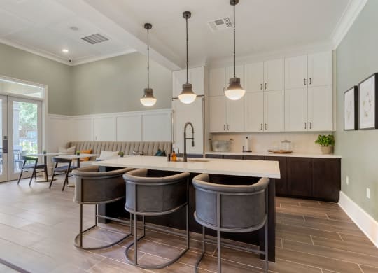 a kitchen with a large island with bar stools at Madison on the Meadow, Stafford, TX