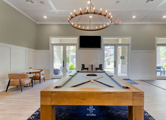 Resident Lounge with Pool Table and Ring Shaped Chandelier  at Madison on the Meadow, Stafford, TX, 77477