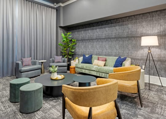 a living room with couches and chairs and a table at Madison on the Meadow, Stafford